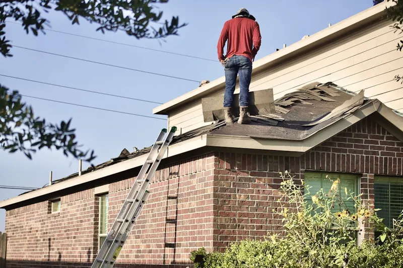 Professional roofer working on a residential roof in College Manor